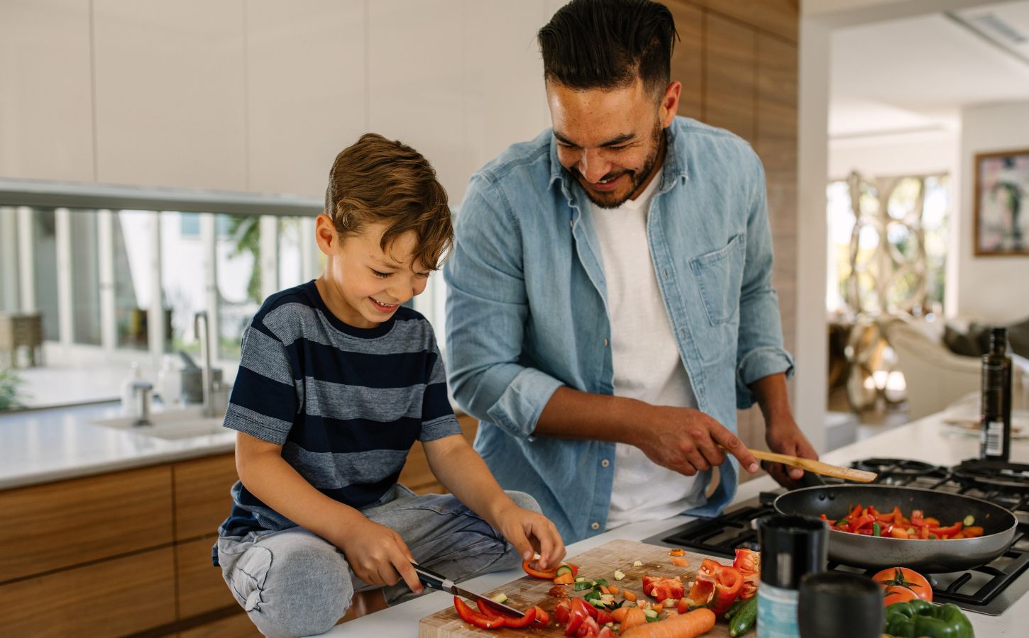 Photo shows a father and son cooking together