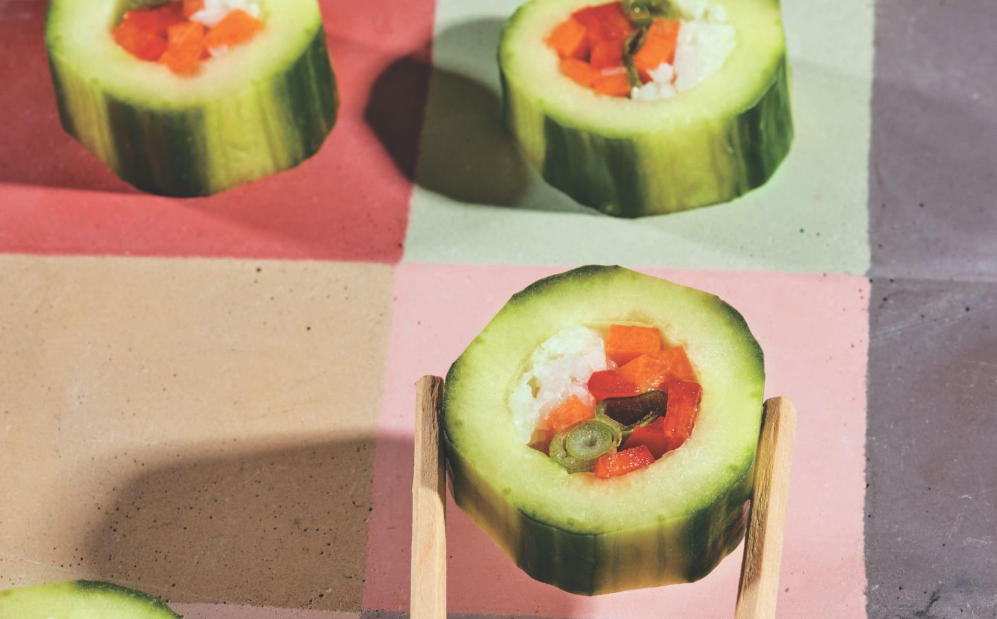 cucumber bites with avocado, bell pepper, carrot, and green onion