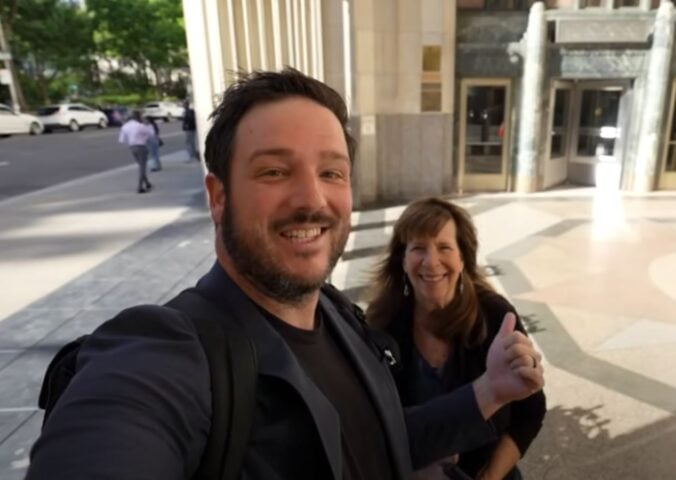 A YouTuber and his mom speaking directly to camera on the street in a video reviewing Eleven Madison Park