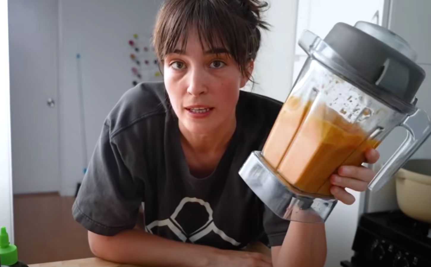 Merle O'Neal holding her romesco sauce in a blender for Tom Brady's high-protein vegan diet