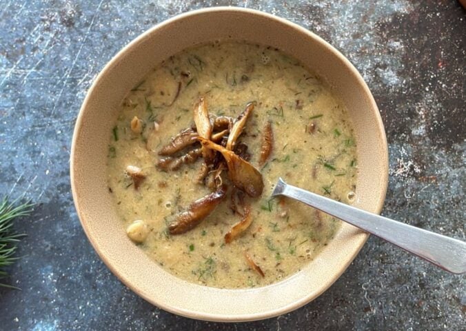 a vegan mushroom and white bean soup with lemon and tahini