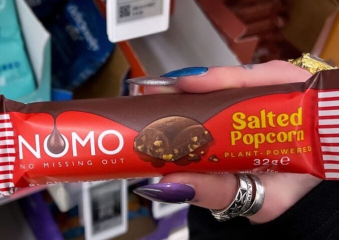 Photo shows one of the new NOMO vegan chocolate bar flavors, "Salted Popcorn"