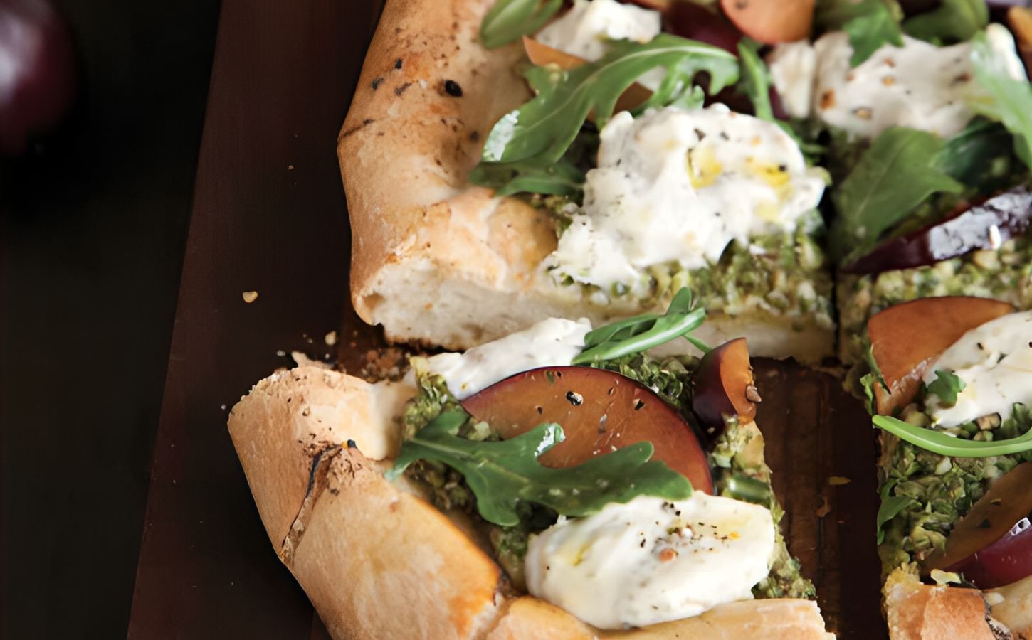 pesto plum pizza with balsamic arugula and basil soy ricotta