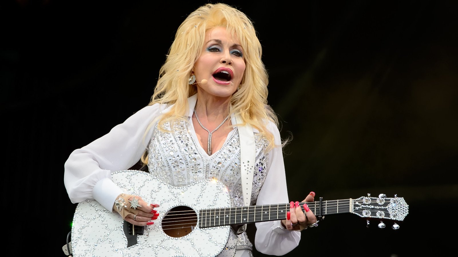 Dolly Parton plays guitar at Glastonbury music festival