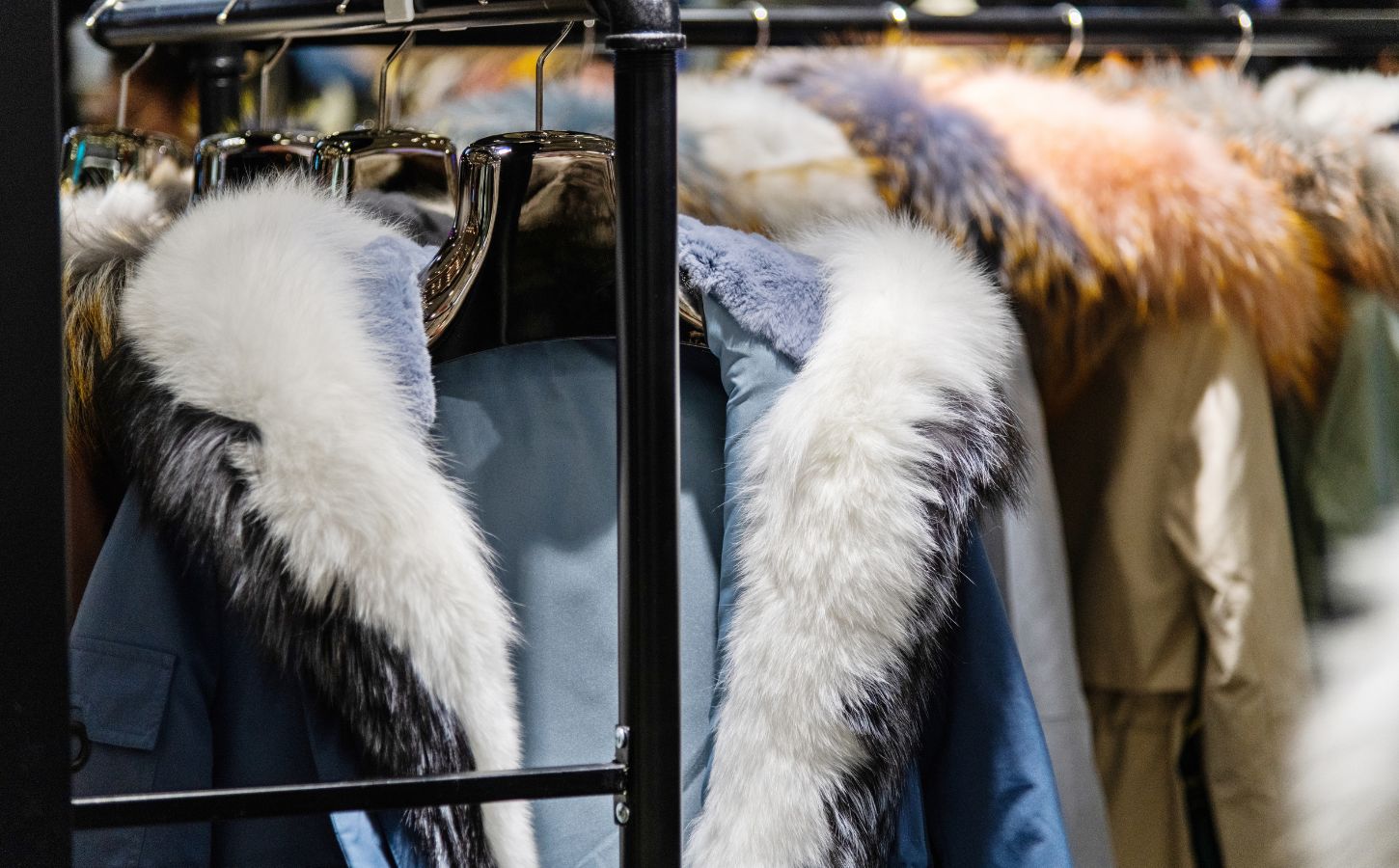 Winter fur coats hung up on a clothing rack