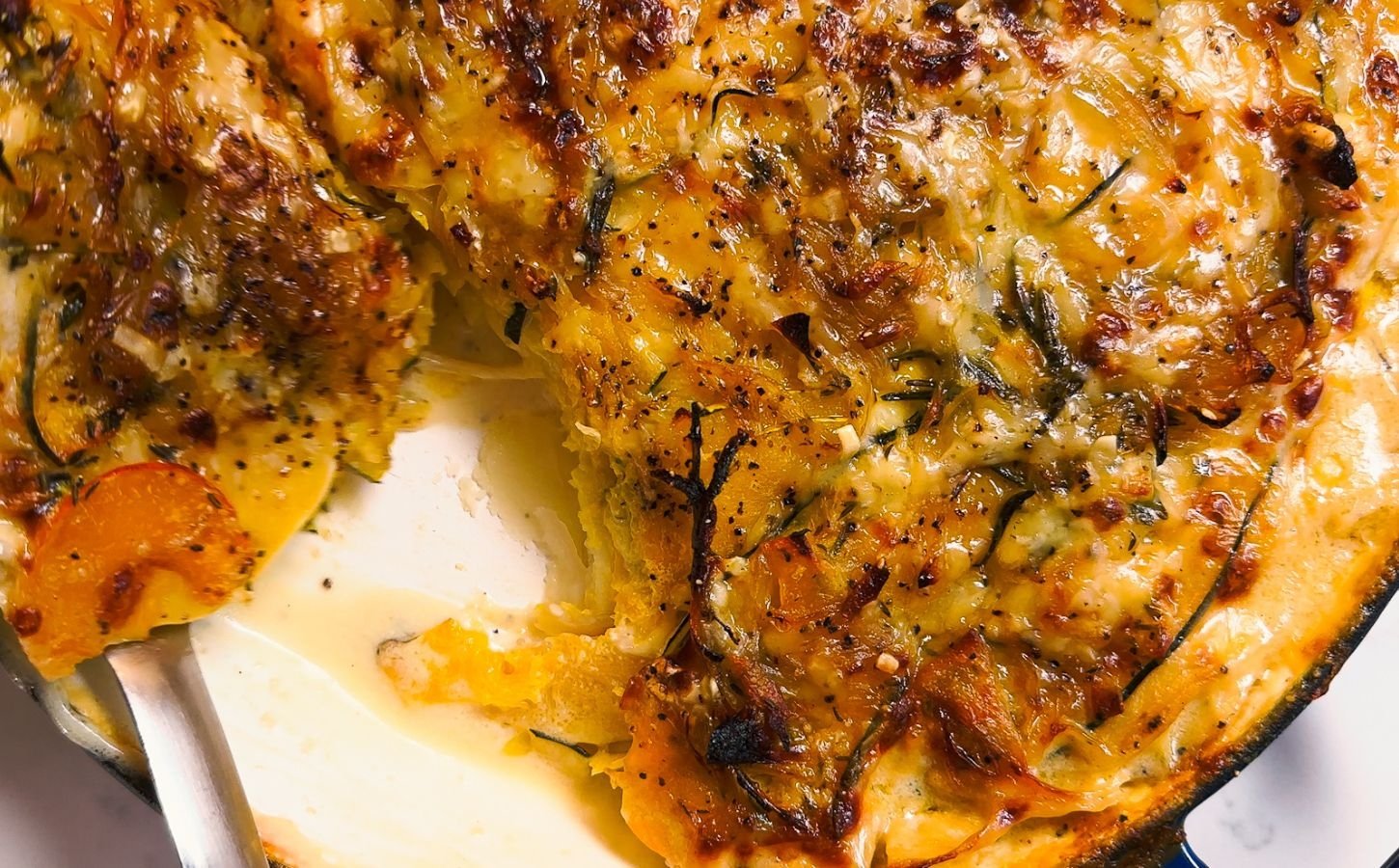 Pumpkin dauphinoise recipe made with layers of pumpkin, potato, and vegan creamy sauce