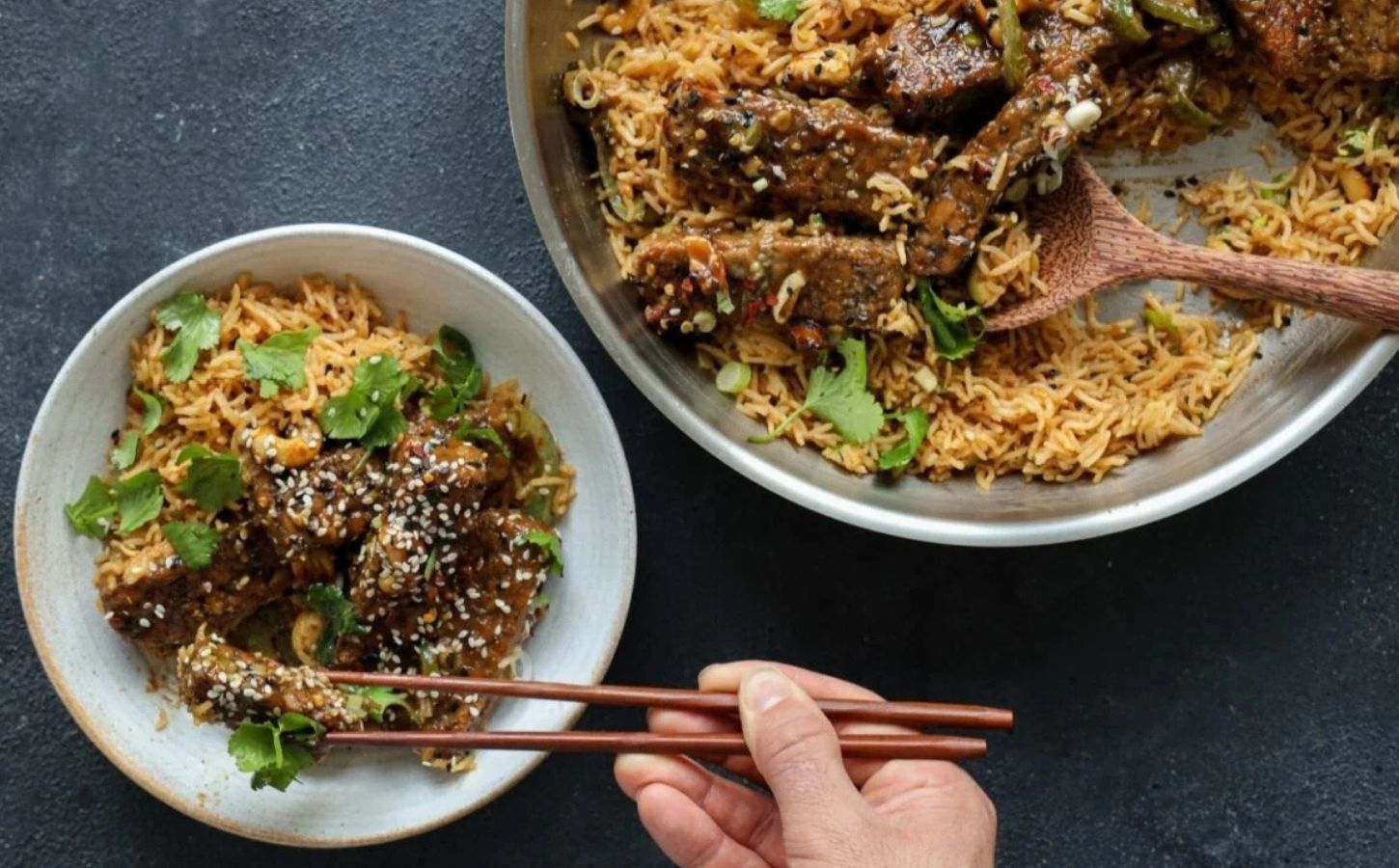 teriyaki glazed tempeh strips cooked with soy, garlic, and sesame over rice