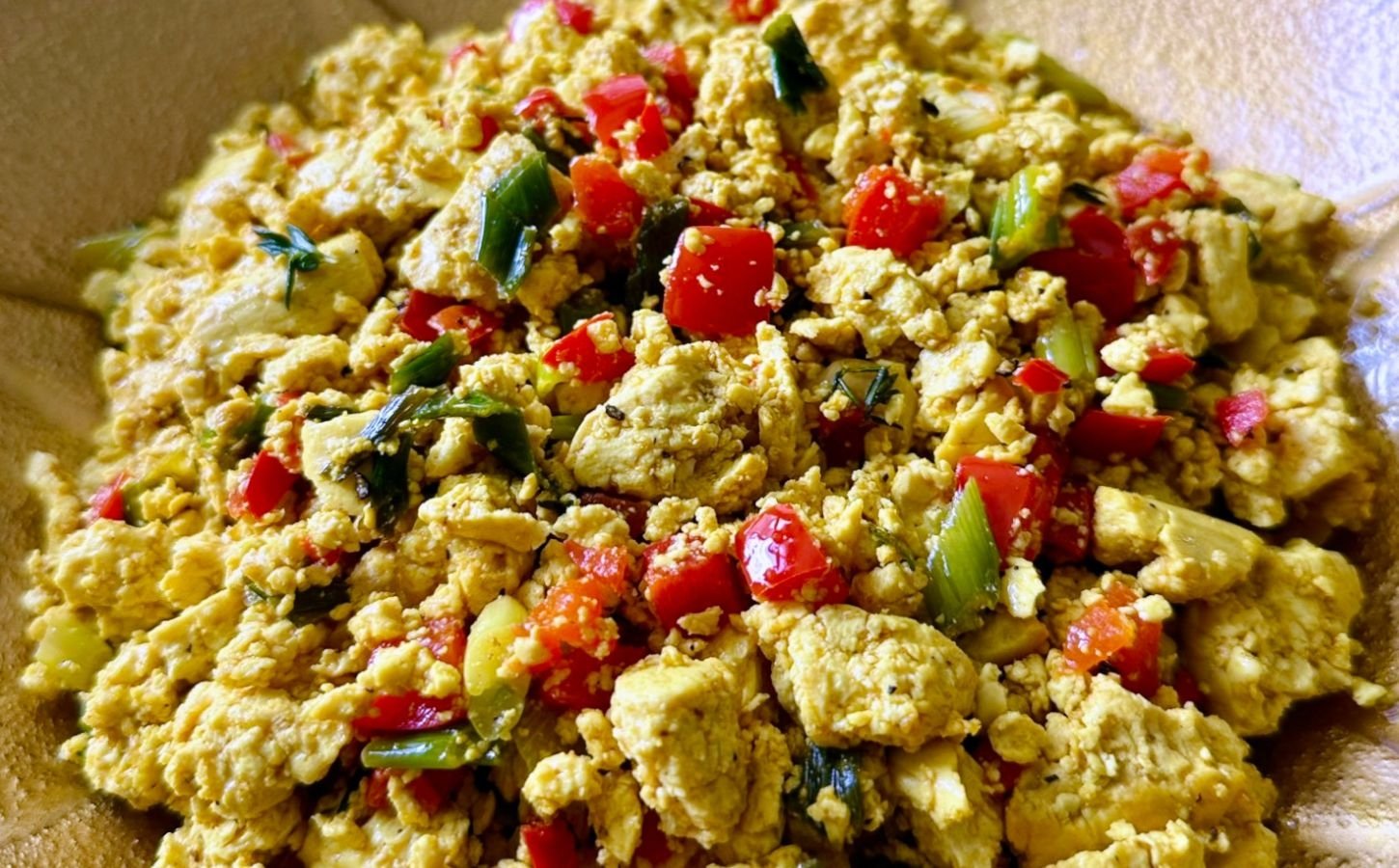 tofu breakfast scramble made with Himalayan black salt, turmeric, bell peppers, and onions