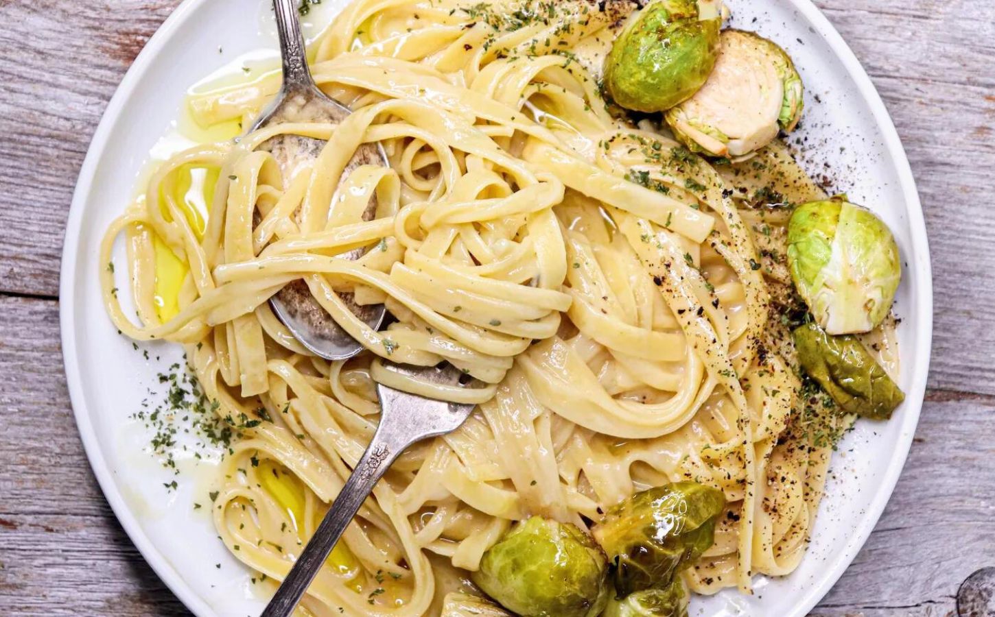 A plate of dairy-free and egg-free creamy Fettuccini Alfredo, made from a vegan recipe