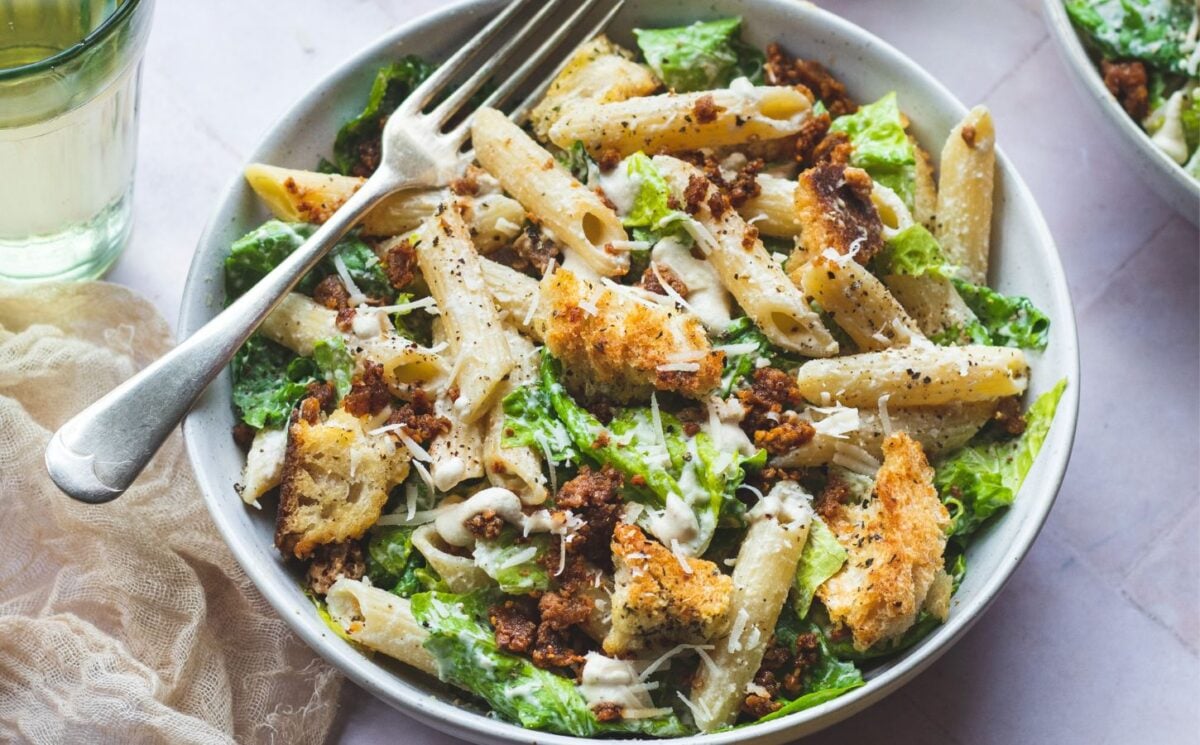 A bowl of plant-based caesar pasta salad, a vegan pasta salad recipe