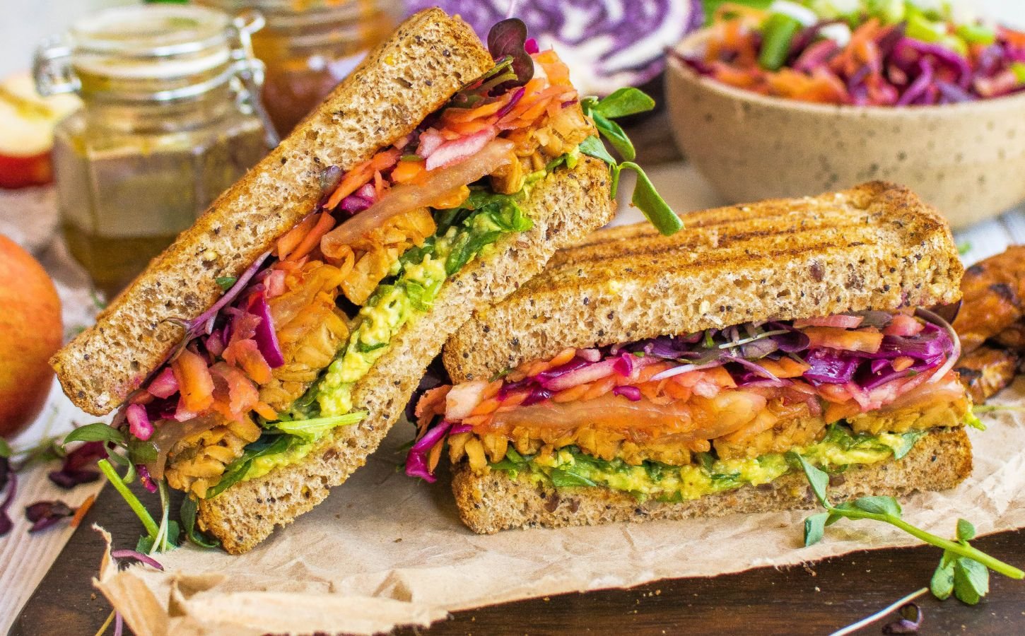A vegan tempeh and apple slaw sandwich