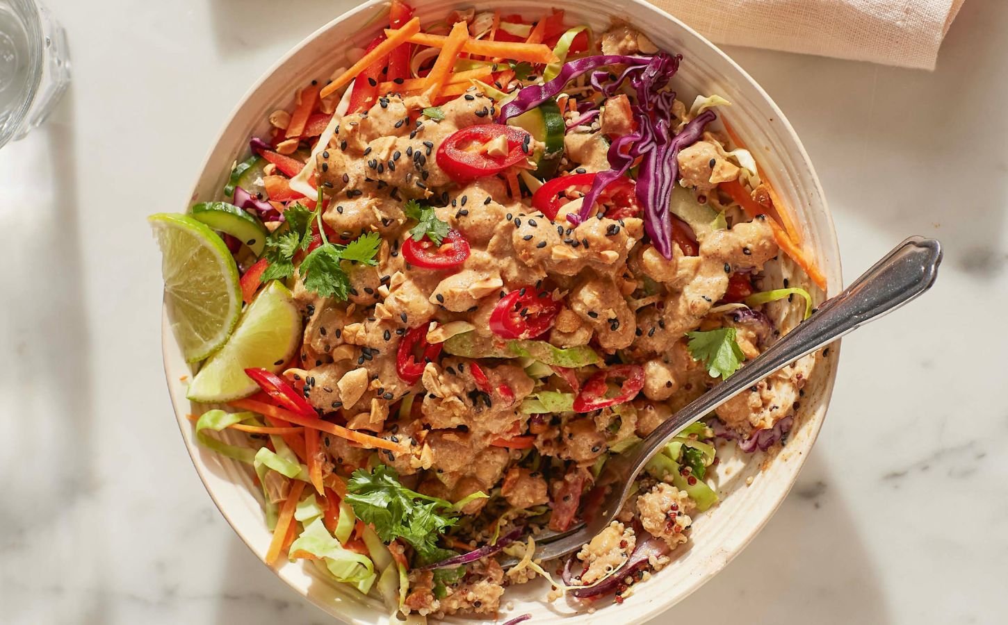 satay chickpea and quinoa salad with veggies and lime