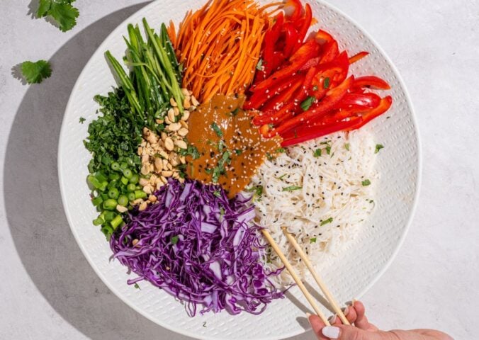 a beautiful bowl of spring roll salad with rice noodles and peanut dressing