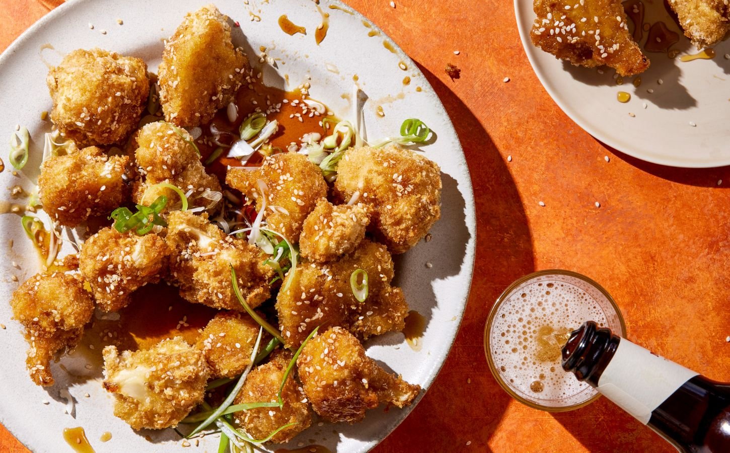 a plate of sticky cauliflower wings with a sticky and sweet sauce