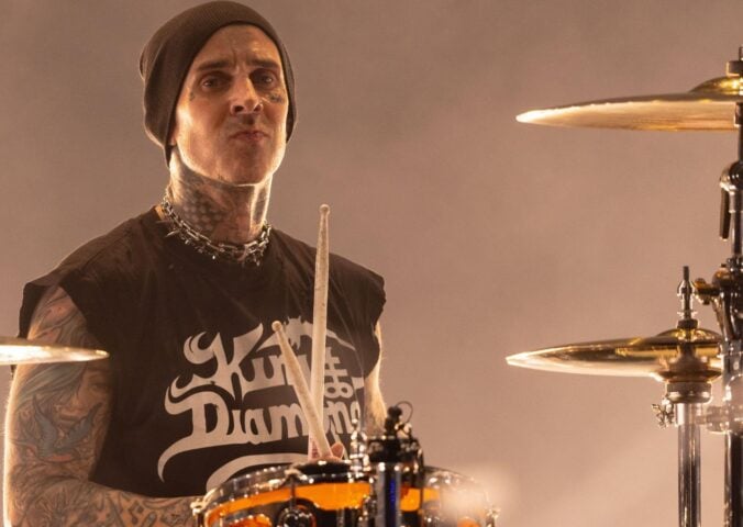 Blink 182 star and vegan celebrity Travis Barker playing the drums on stage