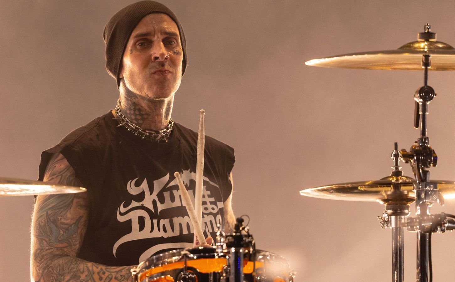 Blink 182 star and vegan celebrity Travis Barker playing the drums on stage