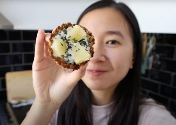 A vegan recipe developer holding up her vegan granola cup recipe