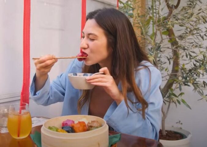Shizuka Anderson, the host of Japan by Food YouTube channel, trying out vegan gyozas in a vegan guide to Japan video