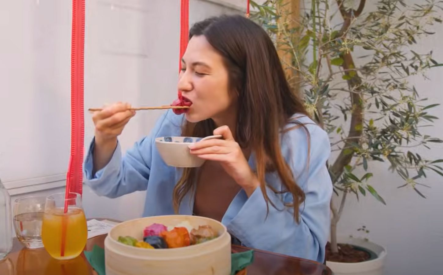 Shizuka Anderson, the host of Japan by Food YouTube channel, trying out vegan gyozas in a vegan guide to Japan video